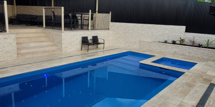 Classic Cream Travertine pool paving and Bookleaf Wall Cladding3